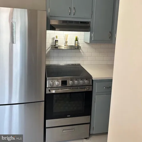 a kitchen with a stove and a refrigerator