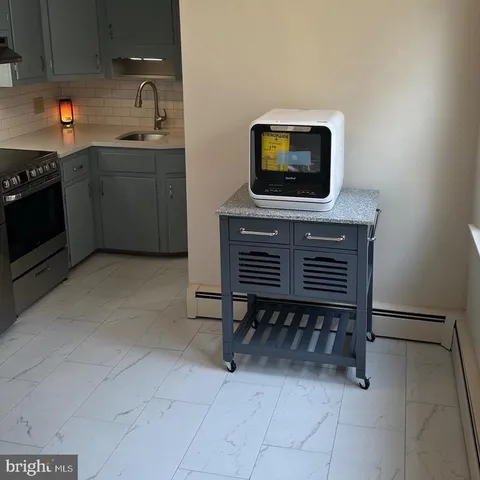 a kitchen with a sink cabinets and appliances