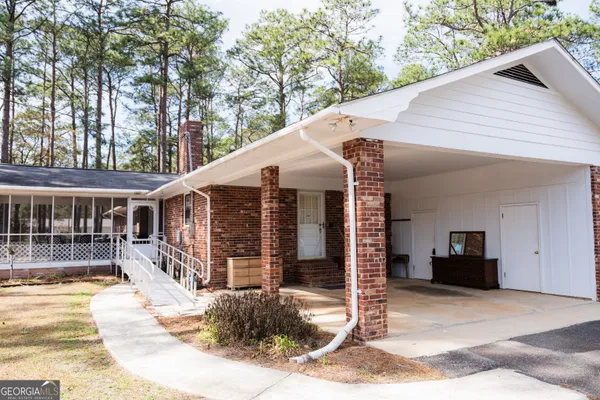 a view of a brick building next to a yard