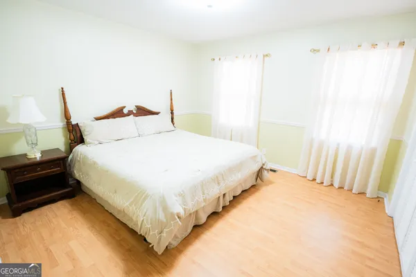 a bathroom with a granite countertop sink a large mirror and a bathtub