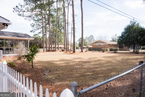 a view of a house with backyard and deck