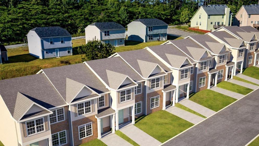 an aerial view of multiple houses with a yard
