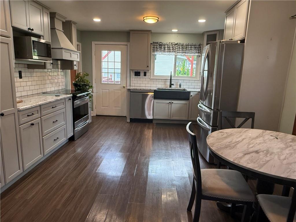 600 Moore Road Washington, PA 15301 - Photo 2 of 16 a kitchen with stainless steel appliances wooden floors and wooden cabinets