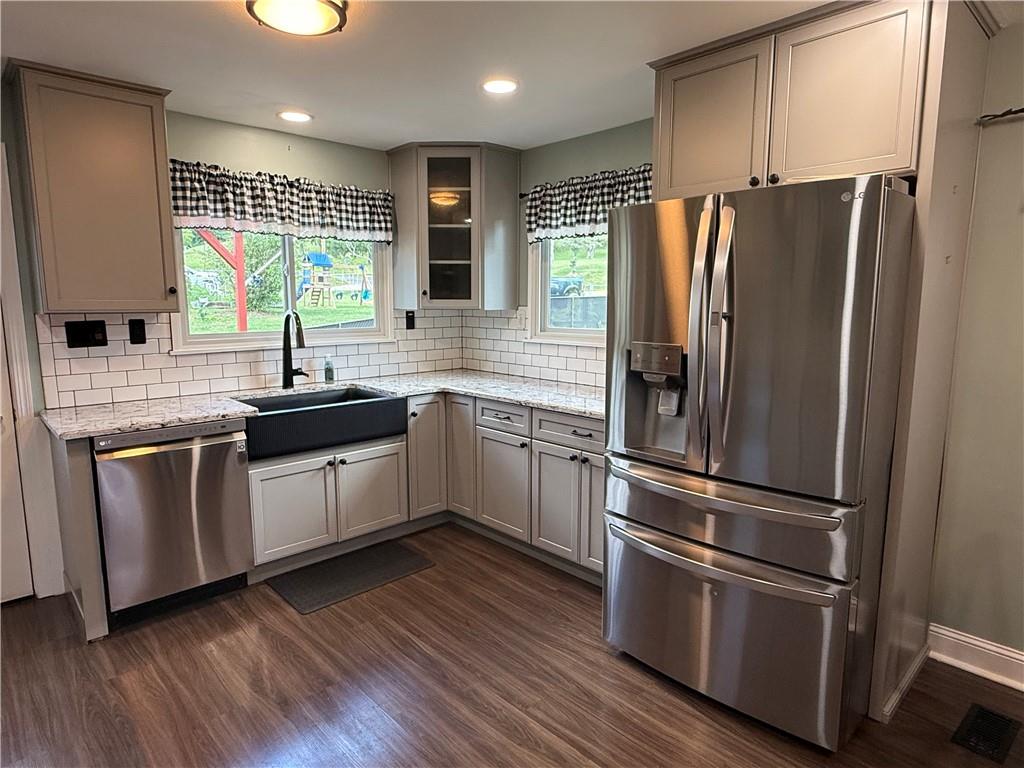 600 Moore Road Washington, PA 15301 - Photo 3 of 16 a kitchen with stainless steel appliances a refrigerator sink and wooden floor