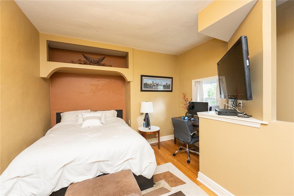 2220 Sarah Street, Unit 2 Pittsburgh, PA 15203 - Photo 14 of 34 a bedroom with a bed and large windows