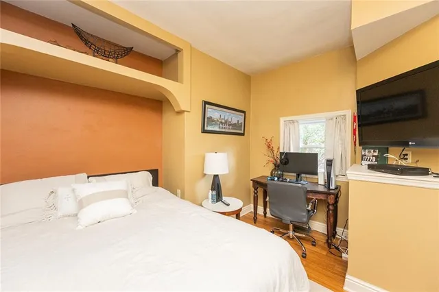 a bedroom with a bed and a flat screen tv