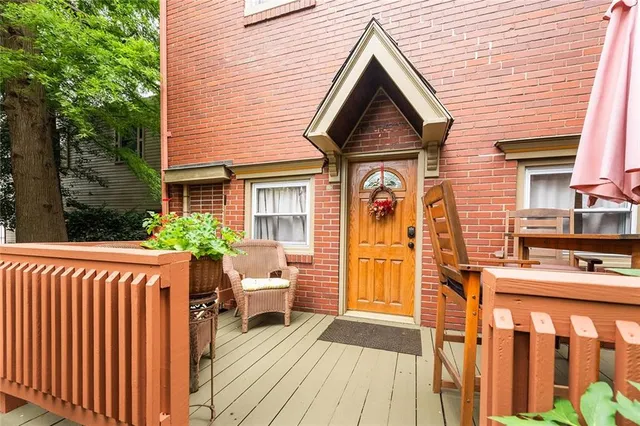 a view of a house with entrance stairs and a garden