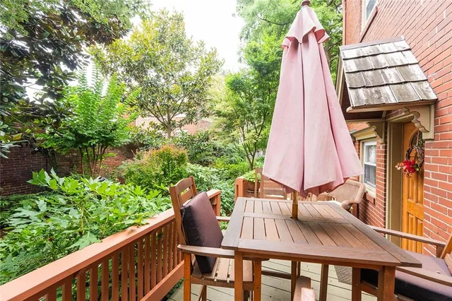 a view of deck with furniture and garden