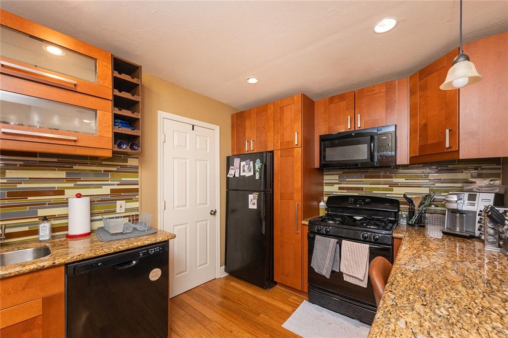 2220 Sarah Street, Unit 2 Pittsburgh, PA 15203 - Photo 2 of 34 a kitchen with stainless steel appliances a stove sink microwave and refrigerator