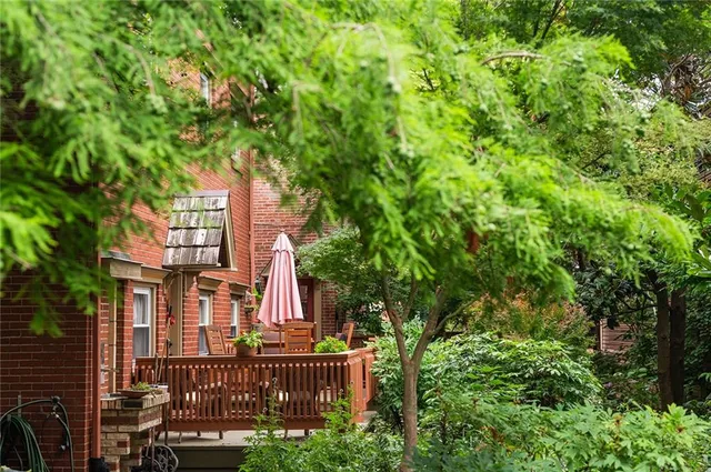 front view of house with a tree
