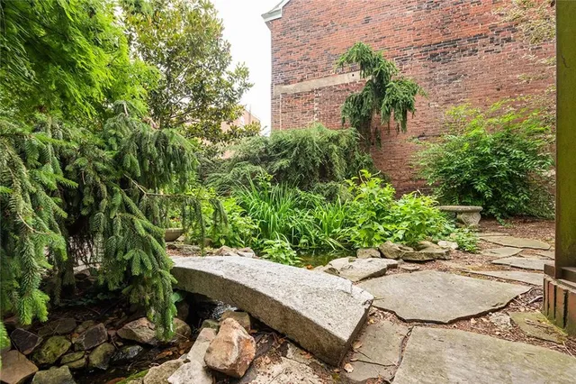 a view of backyard with plants and outdoor seating