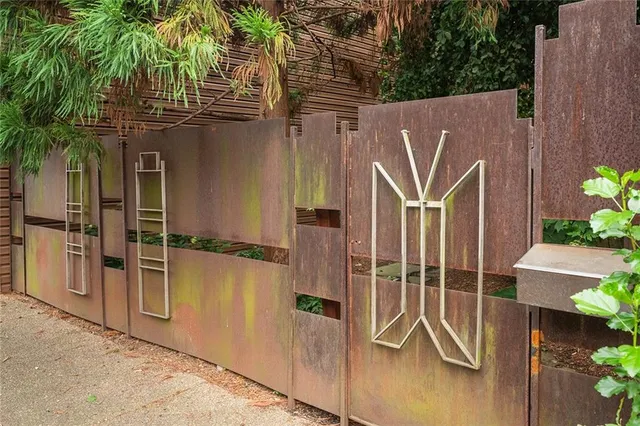 a view of a house with a wooden fence