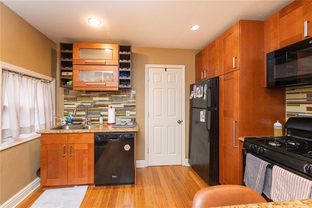 2220 Sarah Street, Unit 2 Pittsburgh, PA 15203 - Photo 4 of 34 a kitchen with stainless steel appliances granite countertop a refrigerator and a stove