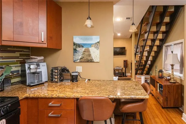 a kitchen with stainless steel appliances granite countertop a stove a sink and a microwave