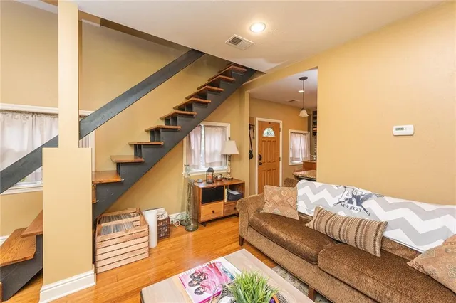 a living room with furniture and wooden floor