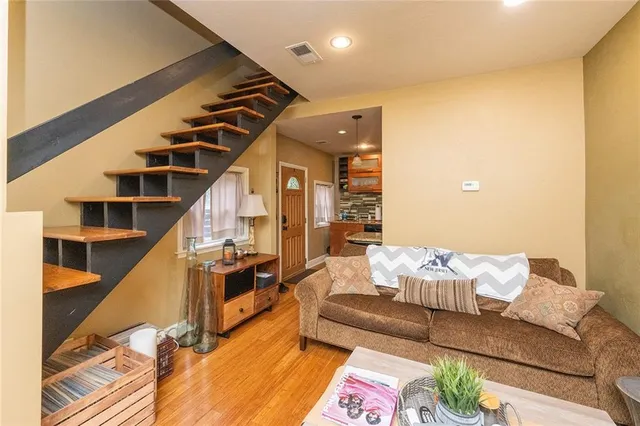 a living room with furniture and stairs