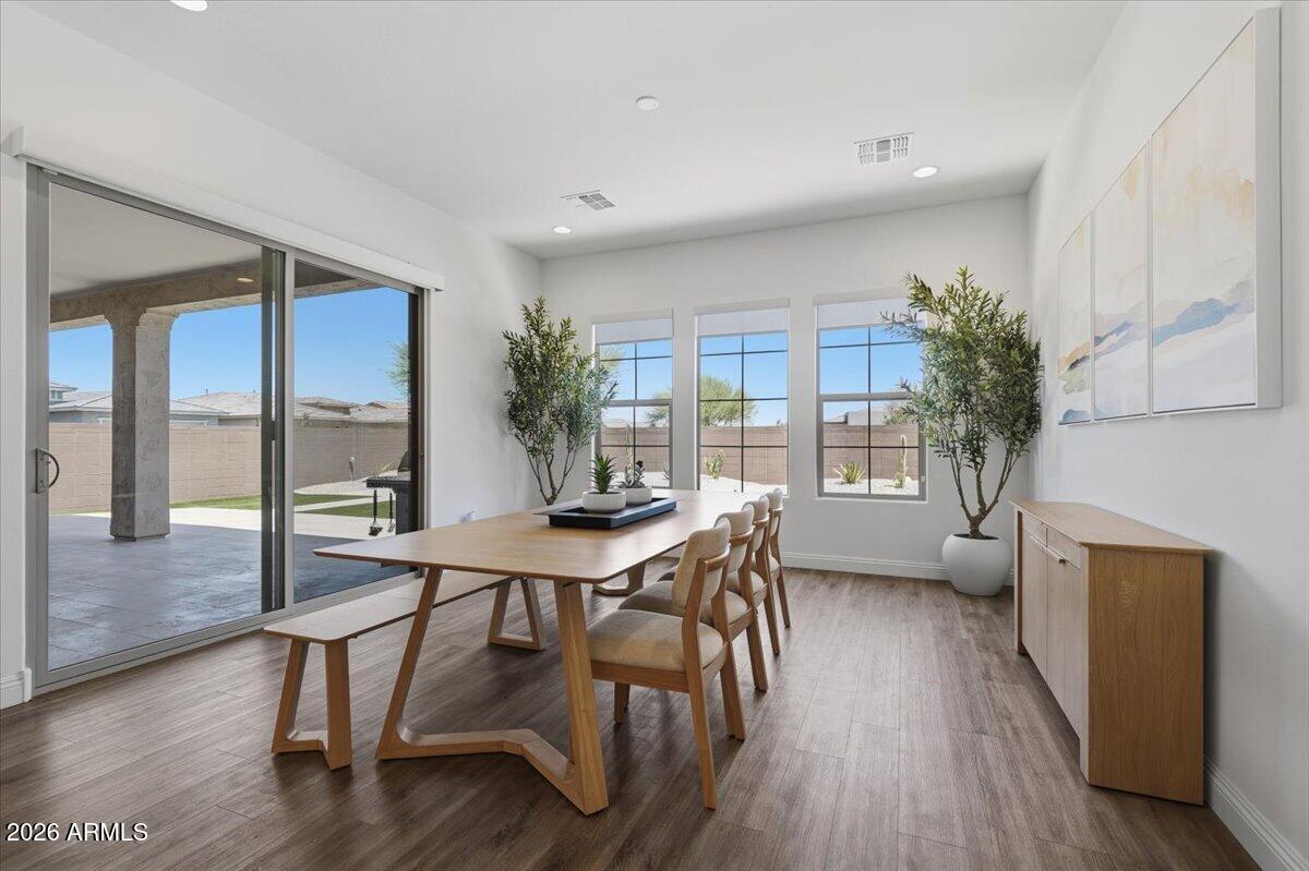 22608 East Stacey Road Queen Creek, AZ 85142 - Photo 28 of 83 a view of a dining room with furniture window and wooden floor