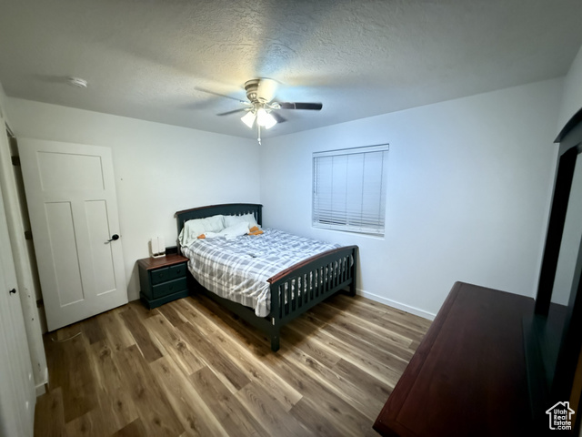 175 North 160 East Hurricane, UT 84737 - Photo 24 of 43 Bedroom featuring wood finished floors, a textured ceiling, and ceiling fan