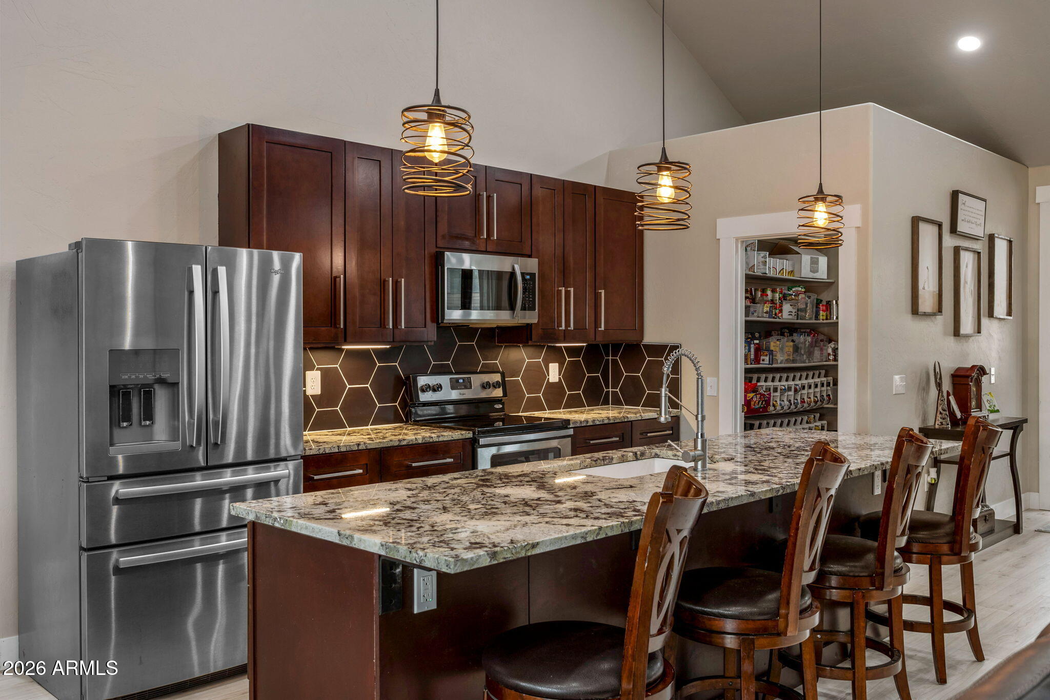 2270 Spitfire Circle Overgaard, AZ 85933 - Photo 11 of 47 a kitchen with stainless steel appliances granite countertop a refrigerator a stove a sink a dining table and chairs