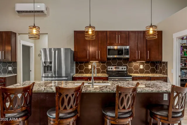 a kitchen with a dining table and chairs