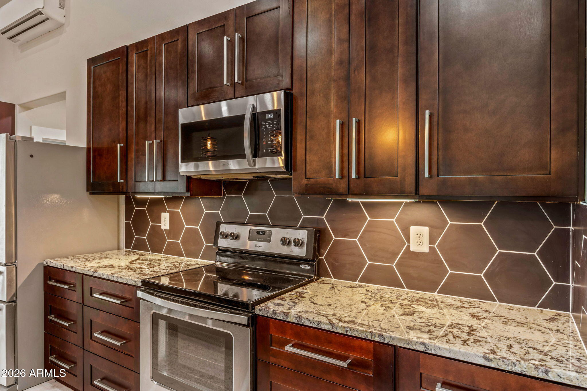 2270 Spitfire Circle Overgaard, AZ 85933 - Photo 13 of 47 a kitchen with granite countertop wooden cabinets and a stove top oven