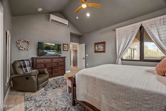 a bedroom with a bed window and dresser