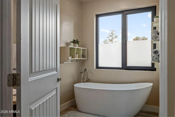 a bathroom with a bathtub and shower