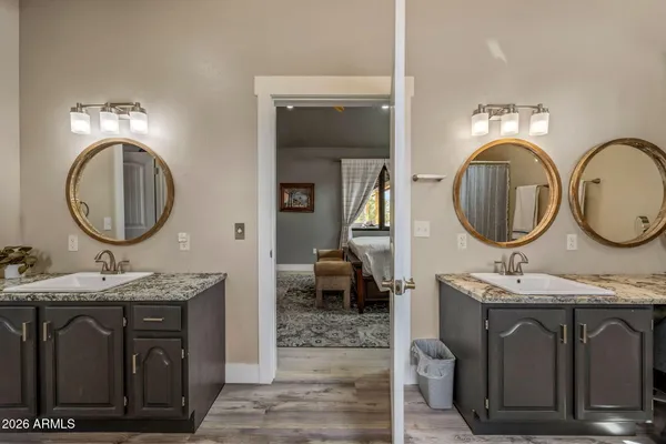 a bathroom with a granite countertop double vanity sink and a mirror