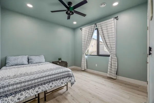 a bedroom with a large bed and a window