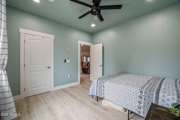 a bedroom with a bed and a ceiling fan