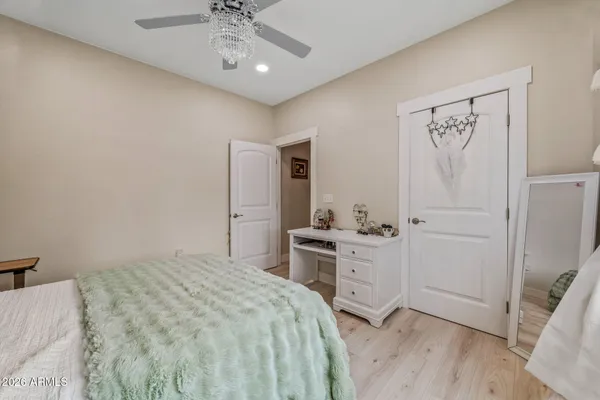 a bedroom with a bed and a chandelier