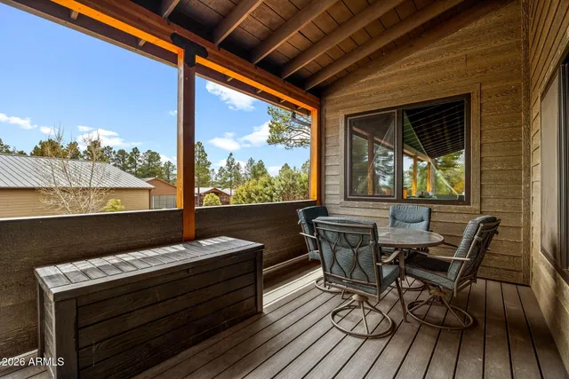 a view of a chairs and table on the deck