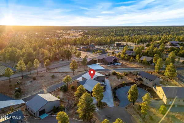 an aerial view of residential houses with outdoor space and ocean view