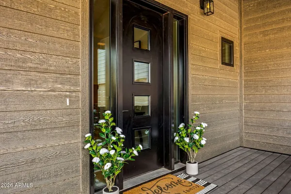 a vase of flowers sitting on a wooden door