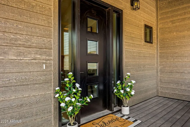 a vase of flowers sitting on a wooden door