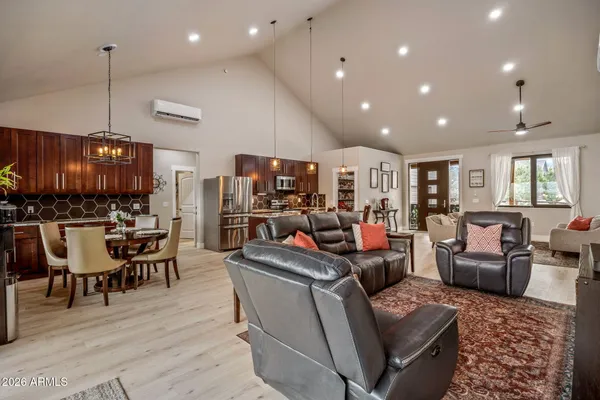 a living room with lots of furniture and kitchen view