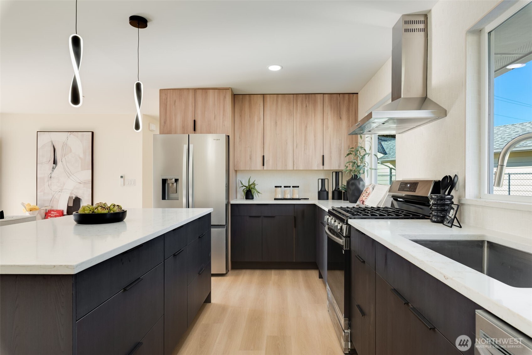 11010 Davisson Road Southwest Lakewood, WA 98499 - Photo 13 of 40 a kitchen with a sink dishwasher a stove a refrigerator and a dining table with wooden floor