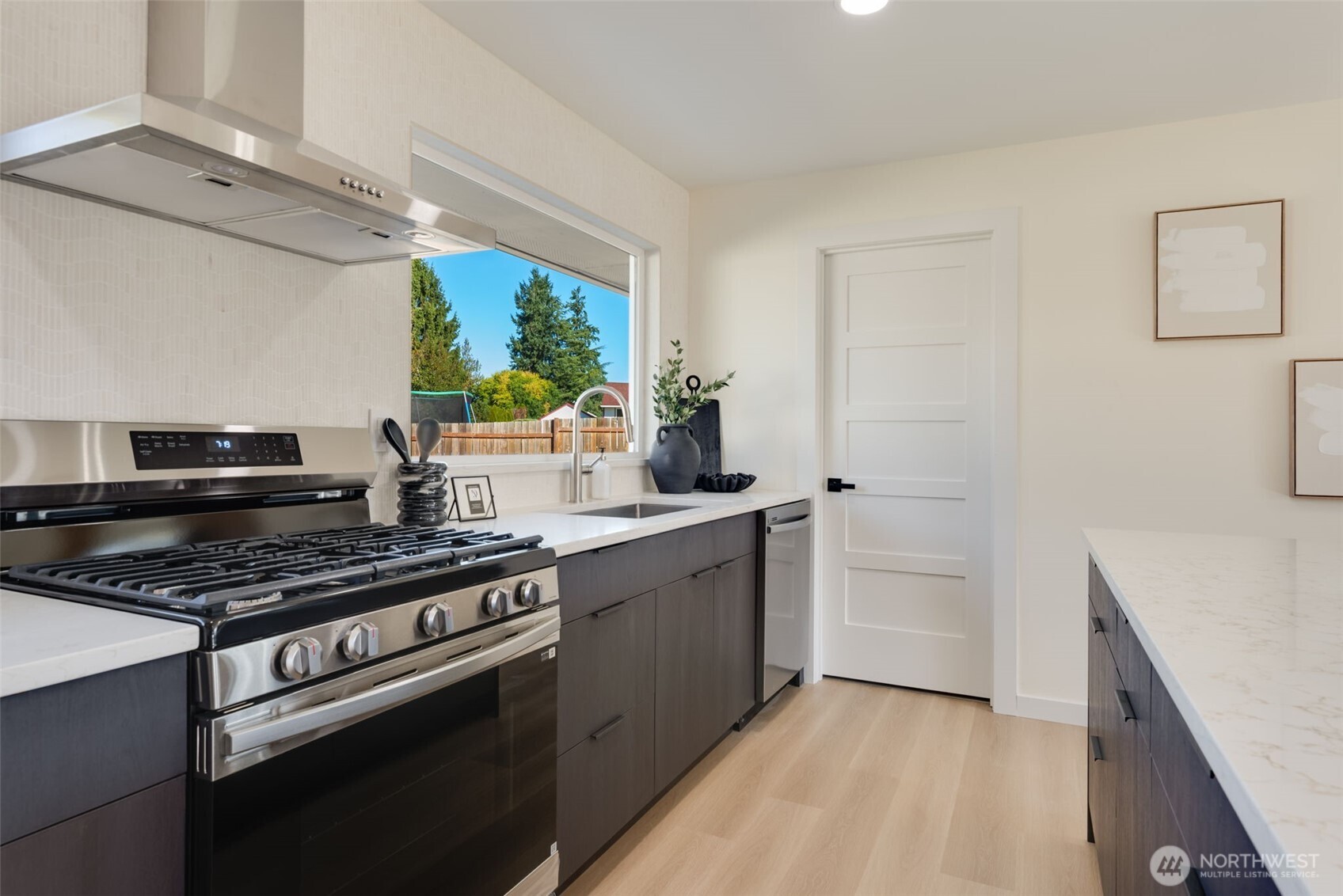 11010 Davisson Road Southwest Lakewood, WA 98499 - Photo 14 of 40 a kitchen with stainless steel appliances a stove a sink and a refrigerator