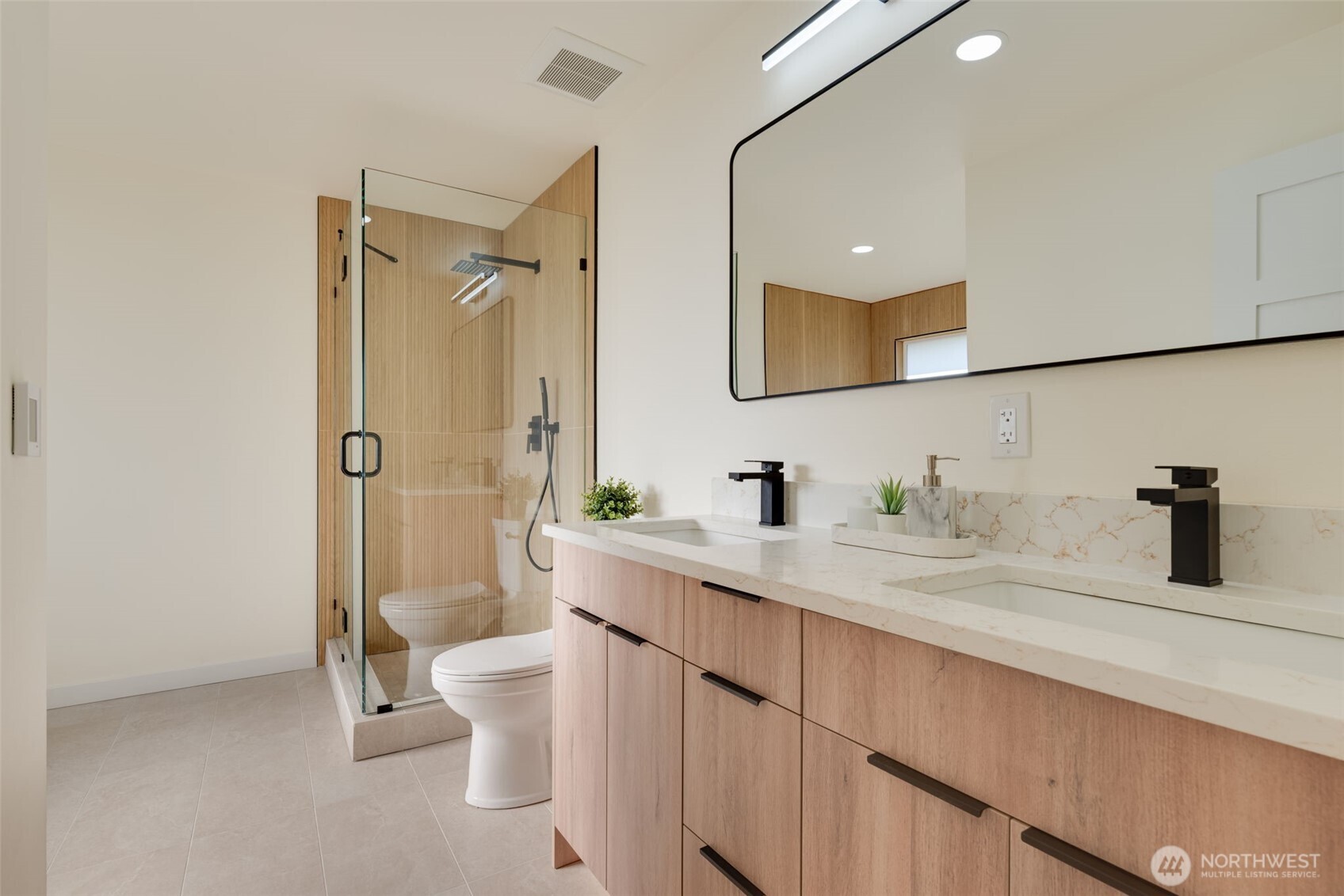 11010 Davisson Road Southwest Lakewood, WA 98499 - Photo 20 of 40 a bathroom with a double vanity sink toilet mirror and shower