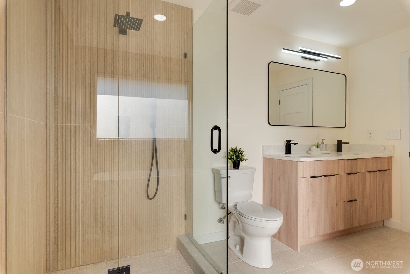 11010 Davisson Road Southwest Lakewood, WA 98499 - Photo 23 of 40 a bathroom with a granite countertop toilet sink and shower
