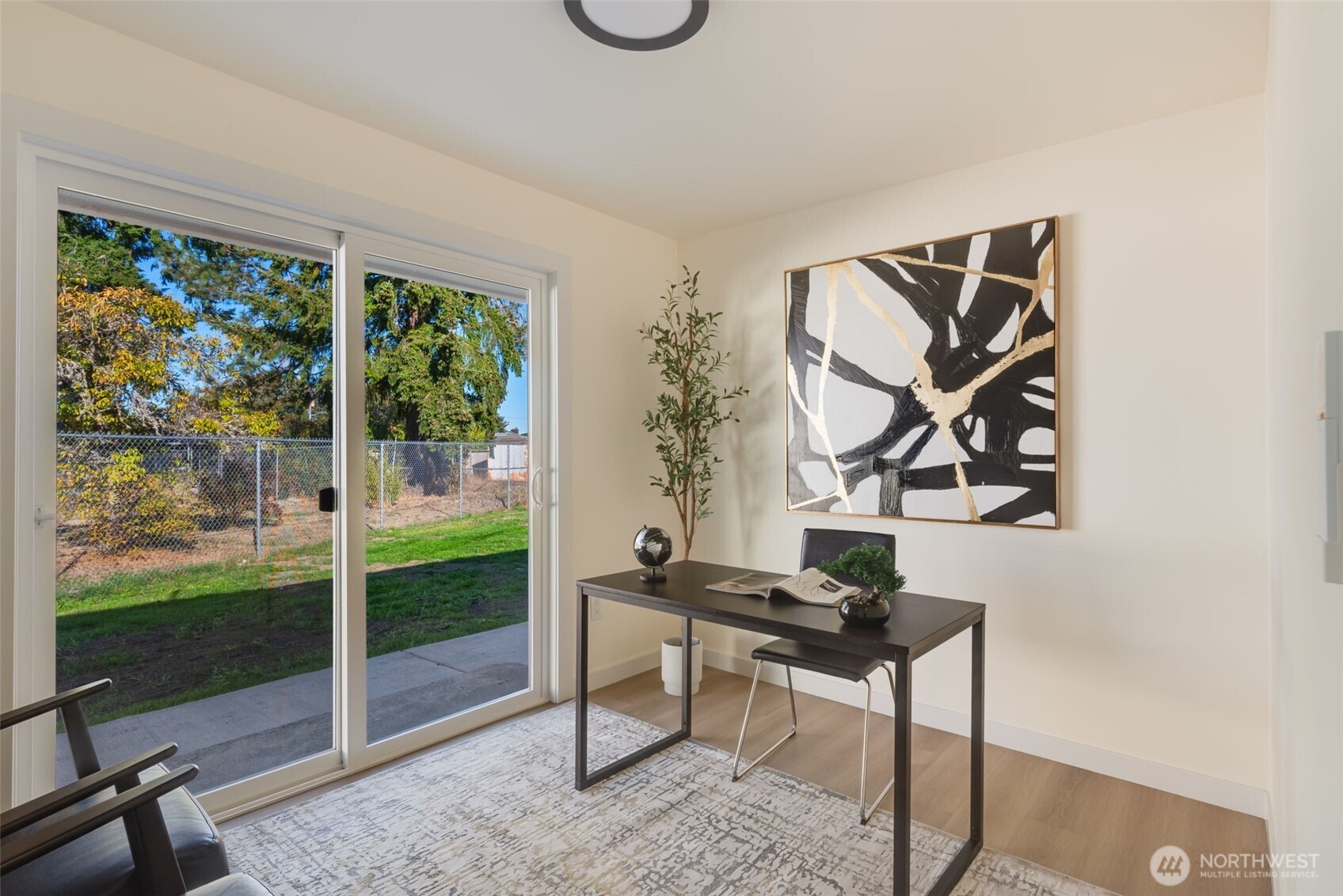 11010 Davisson Road Southwest Lakewood, WA 98499 - Photo 24 of 40 a living room with a couch swing table and a floor to ceiling window