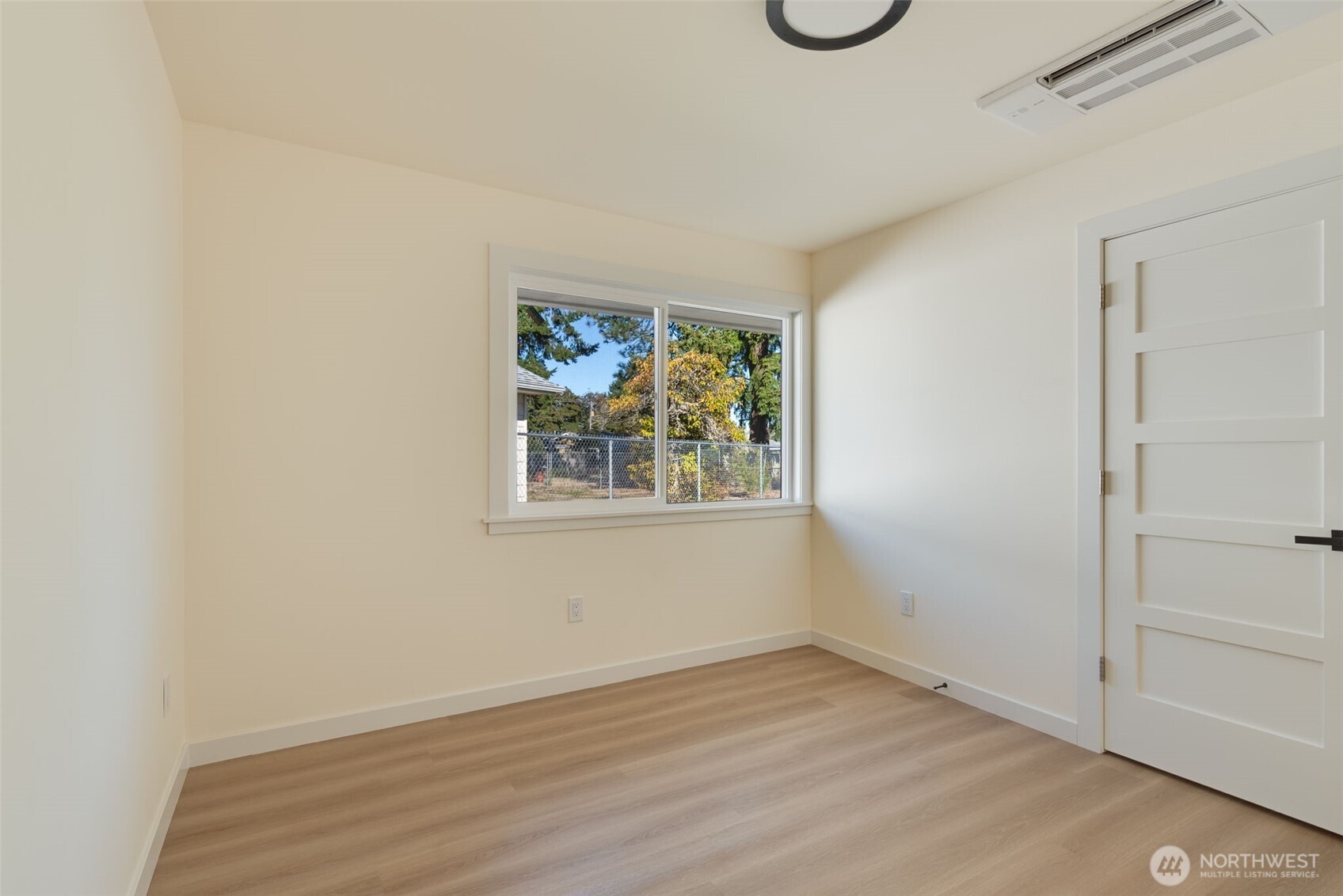 11010 Davisson Road Southwest Lakewood, WA 98499 - Photo 25 of 40 a view of an empty room with window and wooden floor