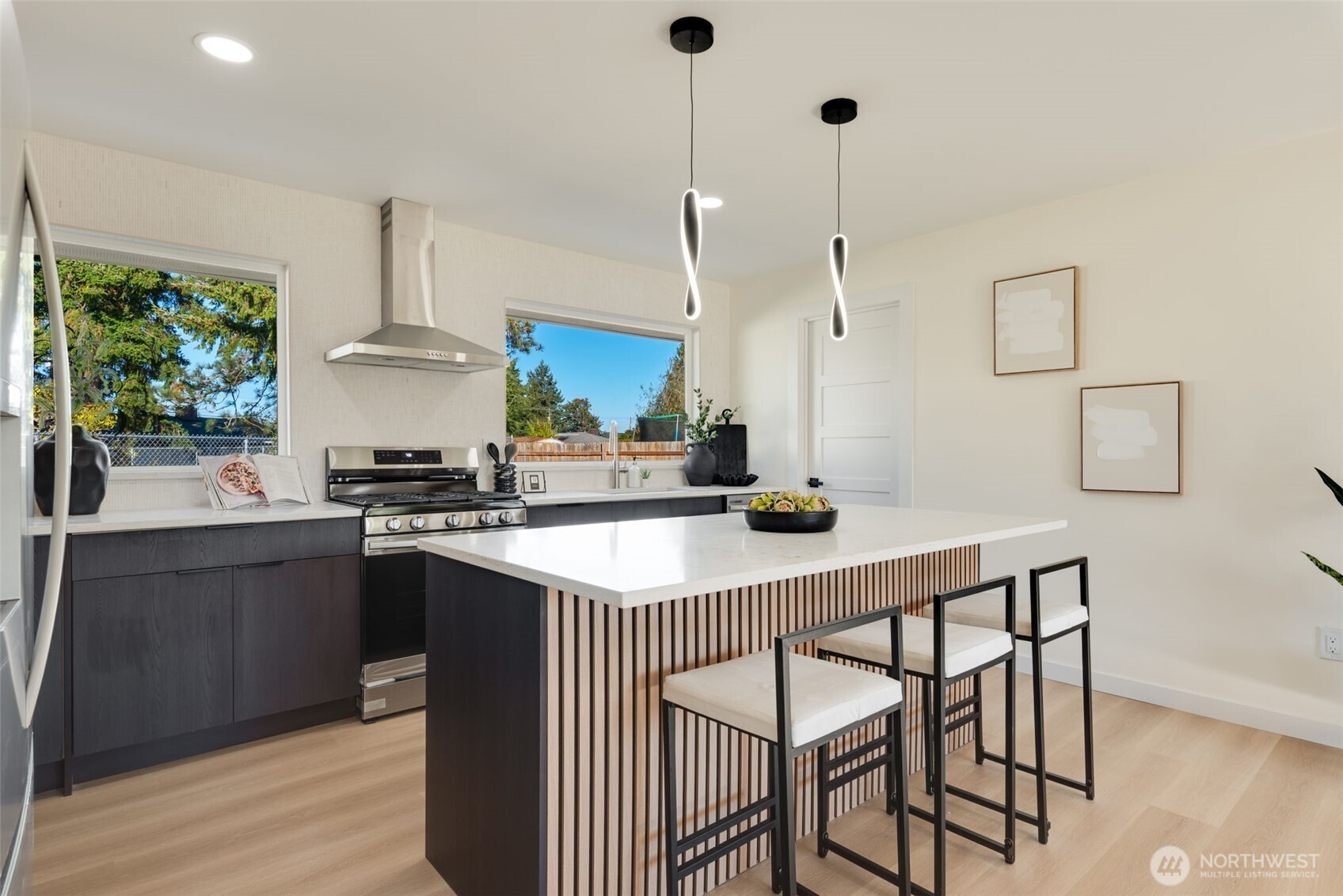 11010 Davisson Road Southwest Lakewood, WA 98499 - Photo 8 of 40 a kitchen with a table a sink and cabinets