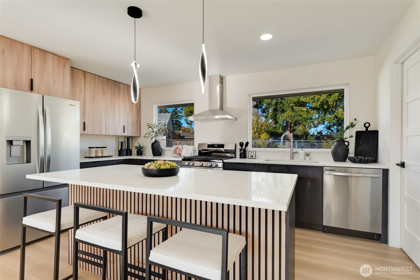 11010 Davisson Road Southwest Lakewood, WA 98499 - Photo 9 of 40 a kitchen with stainless steel appliances granite countertop a sink a stove a refrigerator cabinets and chairs