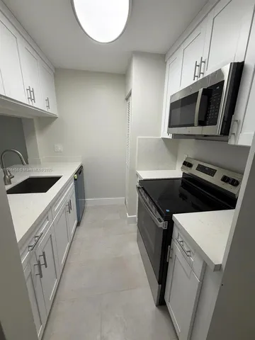 a kitchen with a sink cabinets and utility