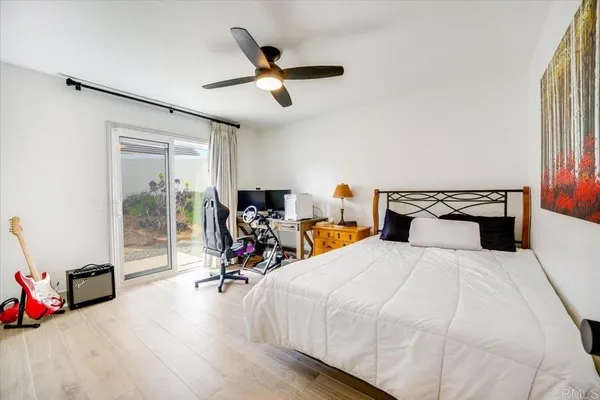 a bedroom with two bed and a large mirror