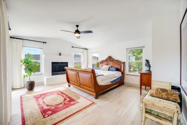 a bedroom with a bed a couch and a potted plant