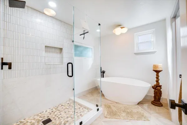 a bathroom with a bathtub and shower