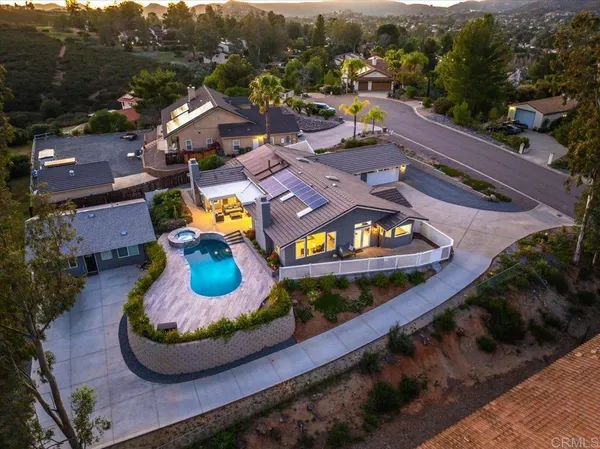 an aerial view of a house with a swimming pool outdoor seating and yard