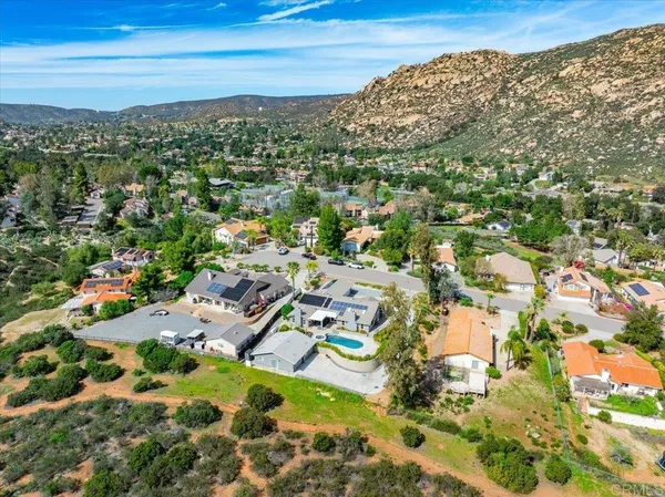 an aerial view of a house with a yard